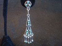 Native American Indian sterling silver jewelry, and Zuni sterling silver jewelry, a beautiful pair of chandelier-style sterling silver dangling earrings, Zuni Pueblo, New Mexico, c. 1940's.  Closeup photo of one earring.
