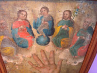 Mexican vintage devotional art, a retablo painted on tin depicting the bleeding Hand of God, c. 1880's (19th century).  Closeup photo of the Trinity near the top of the retablo.