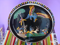 Mexican vintage pottery and ceramics, a lovely blackware pottery charger with excellent artwork, featuring a hunter aiming his gun at an exotic bird, Tonala or San Pedro Tlaquepaque, c. 1930's. Main photo of the charger.