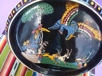 Mexican vintage pottery and ceramics, a lovely blackware pottery charger with excellent artwork, featuring a hunter aiming his gun at an exotic bird, Tonala or San Pedro Tlaquepaque, c. 1930's. Another full view of the hunter and bird.