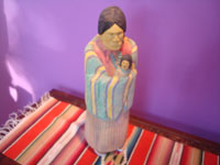 Native American Indian folk art and woodcarving, a wonderful sculpture done in wood and decorated with transparent, watercolor-like colors, by the famous Navajo folk artist, Johnson Antonio, Arizona or New Mexico, c. 1980's. Main photo of the woman and her baby.