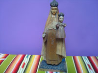 Mexican vintage devotional art. a woodcarving depicting Our Lady of Mt. Carmel holding the infant Christ, by the famous Cortes Family of carvers, Mexico City c. 1940's.  Main photo of the carving.