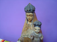 Mexican vintage devotional art. a woodcarving depicting Our Lady of Mt. Carmel holding the infant Christ, by the famous Cortes Family of carvers, Mexico City c. 1940's.  Closeup photo of the faces of Mary and the Infant Jesus.