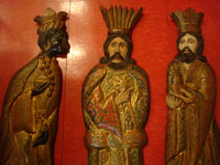 Mexican vintage devotional art and folk art, three beautifully carved wooden figures of the Three Kings or Wise Men, decorated with gesso and gold leaf, Mexico City, c. 1940's. Closeup photo of the Kings showing their faces.