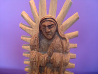 Mexican vintage devotional art, a beautiful woodcarving depicting Our Lady of Guadalupe, Michoacan, c. 1950.  Closeup photo of Our Lady's face.