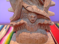 Mexican vintage devotional art, a beautiful woodcarving depicting Our Lady of Guadalupe, Michoacan, c. 1950.  Closeup photo of the angel at Our Lady's feet.