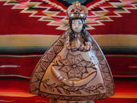 Mexican pottery and ceramics, and Mexican devotional art, a pottery statue of Our Lady of Good Health, from Tzintzuntzan, Michoacan, c. 1980. The piece is in the traditional style of Tzintzuntzan, with a cream-colored background glaze and black (dark-brown) designs. Closeup photo of Our Lady's face.