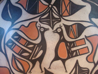Native American Indian pottery and ceramics, a medium/large dough bowl from Santo Domingo Pueblo, c. 1970-80. The designs painted on the bowl are very beautiful and feature wonderful birds and foliage. Closeup photo of the birds on the front of the bowl.