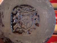 Mexican vintage pottery and ceramics, a beautiful black-ware bottle with exquisite artwork, Tlaquepaque, Jalisco, c. 1930's. Photo showing the bottom of the Tlaquepaque bottle with the stamp of the Arias shop of Tlaquepaque.