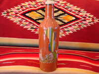 Mexican vintage pottery and ceramics, a beautiful pottery bottle with a brown (earthen-ware) background and very fine and detailed artwork, Tlaquepaque, Jalisco, c. 1930's. Main photo of the Tlaquepaque pottery bottle with earthen-ware background.