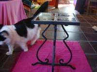 Mexican vintage pottery and ceramics, a wrought-iron table with four matching black-ware tiles, the tiles from Tlaquepaque, Jalisco, c. 1930's. Another side-view of the table.