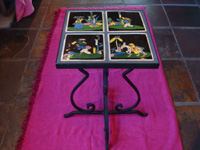Mexican vintage pottery and ceramics, a wrought-iron table with four matching black-ware tiles, the tiles from Tlaquepaque, Jalisco, c. 1930's. Another side-view of the wrought-iron table.