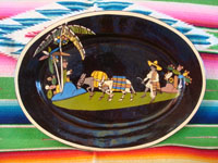 Mexican vintage pottery and ceramics, a black-ware, oval charger with exquisite and very endearing artwork, Tlaquepaque or Tonala, Jalisco, c. 1930's. Main photo of the Tlaquepaque pottery charger.