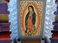 New Mexican vintage devotional art, and New Mexican vintage folk art. a wonderful retablo depicting Our Lady of Guadalupe, done on hand-adzed wood with a surrounding stamped tinwork-art frame, New Mexico, c. 1990. A closer look at the painting of Our Lady of Guadalupe.