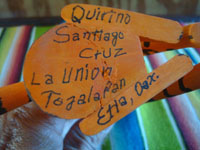 Mexican vintage folk art, and Mexican vintage woodcarvings and masks, a wonderful carved wooden leopard with beautiful painted decorations, signed on the bottom "Quirino Santiago Cruz, Etla, Oaxaca", c. 1970's.  Photo of the bottom of the carving with the artist's signature.