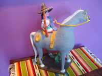 Mexican vintage folk art, a wonderful pottery statue of a woman brandishing her rifle and mounted on a spirited horse, Santa Cruz de las Huertas, Jalisco, c. 1950's. Another side view of the woman and her horse.
