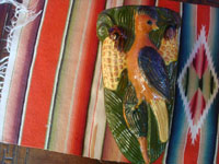 Mexican vintage pottery and ceramics, a beautiful pair of pottery wall-sconces with wonderful glazing and featuring a bird on each sconce eyeing delicious corn, San Pedro Tlaquepaque, c. 1940's. Photo showing one of the pottery sconces.
