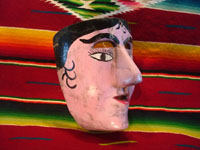 Mexican vintage wood carving and Mexican vintage folk art, a dance mask depicting a European woman, from Guerrero, c. 1930-40. View of the side of the mask.
