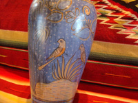 Mexican vintage pottery and ceramics, a beautiful Tonala burnished vase or large jar with a blue background and a "starry-night" background-design, Tonala, Jalisco, c. 1930. A closeup photo of the lovely birds decorating the sides of the Tonala pottery vase.