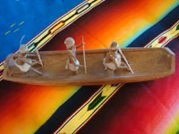Native American Indian vintage folk art, a wonderful carved wooden canoe with Indians busilly paddling in search of some tasty salmon, Klamath or Karok, c. 1920. A side view of the canoe and paddlers.