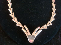 Mexican vintage sterling silver jewelry, and Taxco vintage silver jewelry, a very lovely sterling silver necklace with geometric "V", or "Victory" design, Taxco, c. 1940's. Closeup photo of the "V" at the bottom of the Taxco silver jewelry necklace.