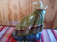 Mexican vintage folk art, and Mexican vintage pottery and ceramics, a lovely glazed statue of a Mexican gentleman relaxing and peering over the edge of his wonderful serape (sarape), Tonala or San Pedro Tlaquepaque, c. 1940.  Photo of the back of the piece.