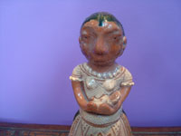 Mexican vintage folk art, a pottery figure of a Purepecha woman and child, Michoacan (very possibly from the city of Capula), c. 1970's. Closeup photo of the woman's face.