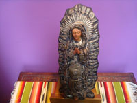 Mexican vintage devotional art, a beautiful woodcarving of Our Lady of Guadalupe decorated with hundreds of milagros, Mexico, c. 1950. Main photo of the statue.