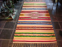 Mexican vintage textile, a Saltillo sarape, c. 1920. Woven of very fine wool with silk in the center diamond and side-bar decorations. 