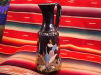 Mexican vintage pottery and folk art, a pair of blackware pouring vessels from Tlaquepaque, Jalisco, c. 1930-40. The vessels are decorated with very inticate scenes. Photo of one cruet.