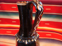 Mexican vintage pottery and folk art, a pair of blackware pouring vessels from Tlaquepaque, Jalisco, c. 1930-40. The vessels are decorated with very inticate scenes. Photo showing the handle of one vessel.