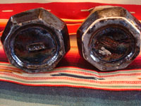 Mexican vintage pottery and folk art, a pair of blackware pouring vessels from Tlaquepaque, Jalisco, c. 1930-40. The vessels are decorated with very inticate scenes. Photo of the bottoms of the two vessels.