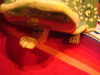 Mexican vintage pottery and ceramics and Mexican vintage folk-art, a lovely pottery figurine depicting a lovely woman with a basketl, Tonala or Tlaquepaque, Jalisco, c. 1930's. The woman's face is incredibly beautiful. Closeup photo of the Tlaquepaque maiden's feet beneath her lovely dress.