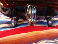 Mexican vintage pottery and ceramics, a black-ware bowl with a tri-pod base, Tlaquepaque, Jalisco, c. 1930's. The bowl has a very graceful and beautiful form, and the artwork on the bowl is very sharp and intricate. Photo showing the feet of the Tlaquepaque pottery bowl.