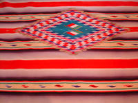 Mexican vintage textiles, and Mexican vintage Saltillo serapes (sarapes), a stunning Saltillo serape with color-hues of soft-red, lilac, purple, green, and soft-yellow, c. 1910-20.  Another view of the center medallian of the serape.