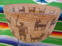 Native American Indian antique woven baskets and basket-weaving, a stunning Pima basket decorated with a figure of a man throwing a stick to his nineteen doggies, Pima, Arizona, c. 1915-20.  Closeup photo of the man throwing a stick on the side of the Pima basket.