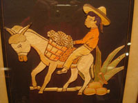 Mexican vintage straw-art (popote art or popotillo), a wonderful popote art scene of a boy riding his trusty burro, laden with goods, to the local market, c. 1940's. This piece of Mexican popote art is comprised of thousands of minute pieces of dyed straw; this is very labor intensive and wonderful! Main photo.