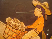 Mexican vintage straw-art (popote art or popotillo), a wonderful popote art scene of a boy riding his trusty burro, laden with goods, to the local market, c. 1940's. This piece of Mexican popote art is comprised of thousands of minute pieces of dyed straw; this is very labor intensive and wonderful! Closeup view of the boy's face.