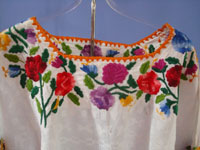 Mexican and Guatemalan vintage textiles and huipiles, a beautiful Guatemalan huipil with wonderful embroidered flowers, Coban, Guatemala, c. 1950.  Closeup photo of the floral embroidery aroung the neck.