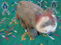 Mexican vintage folk art, and Mexican vintage woodcarvings and masks, a Tarahumara wood-carved racoon or badger, with wonderful subtle colors and form, and primitive appearance, Sonora, c. 1960's. A closeup photo of the face of the racoon.
