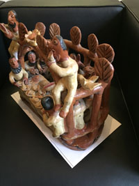 Mexican vintage folk art, a wonderful pottery sculpture of a Last Supper scene with humans and devils sitting down to a feast, Ocumicho, Michoacan, c. 1950. Side view of the sculpture.