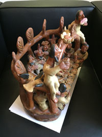 Mexican vintage folk art, a wonderful pottery sculpture of a Last Supper scene with humans and devils sitting down to a feast, Ocumicho, Michoacan, c. 1950. A view from the second side of the sculpture.