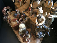 Mexican vintage folk art, a wonderful pottery sculpture depicting the Nativity and the visit of the three kings bearing gifts, Ocumicho, Michoacan, c. 1950's. A closeup photo of one corner of the sculpture showing the devil.