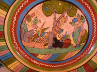Mexican vintage pottery and ceramics, a beautiful petatillo (with a cross-hatching background resembling a straw mat, or petate, in Spanish) charger with very fine artwork and a colorful and very beautiful border, Tonala or San Pedro Tlaquepaque, c. 1940's. Closeup photo of the artwork on the charger.