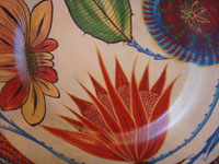 Mexican vintage pottery and ceramics, a very beautiful burnished charger with fine floral artwork against a lovely beige background, Tonala, Jalisco, c. 1930's. Closeup photo of the floral artwork on the front of the charger.
