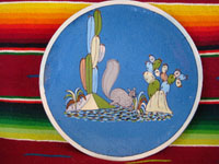 Mexican vintage pottery and ceramics, a lovely blue-ware plate from Tlaquepaque, Jalisco, c. 1940. The blue background glazing is very beautiful, and the rural scene on the plate is finely painted. It features a frolicking squirrel amidst plants and cacti. Main photo of the plate.