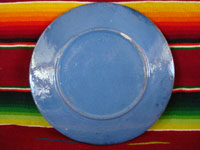 Mexican vintage pottery and ceramics, a lovely blue-ware plate from Tlaquepaque, Jalisco, c. 1940. The blue background glazing is very beautiful, and the rural scene on the plate is finely painted. It features a frolicking squirrel amidst plants and cacti. Photo of the back side of the plate.