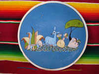 Mexican vintage pottery and ceramics, a lovely blue-ware plate from Tlaquepaque, Jalisco, c. 1940. The blue background glazing is beautiful, and the scene the is very finely painted. This plate matches DD-2 above in size, and is probably by the same artist. It features a graceful deer resting amidst foliage. Main photo.