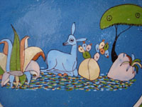 Mexican vintage pottery and ceramics, a lovely blue-ware plate from Tlaquepaque, Jalisco, c. 1940. The blue background glazing is beautiful, and the scene the is very finely painted. This plate matches DD-2 above in size, and is probably by the same artist. It features a graceful deer resting amidst foliage. Closeup photo of the central design showing the deer amidst foliage.
