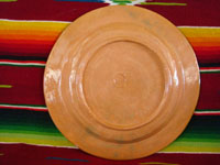 Mexican vintage pottery and ceramics, a lovely terra-cota plate from Tlaquepaque, Jalisco, c. 1940. The peach-colored background glazing is beautiful. The scene on the plate is exceptional; it features a snoozing campesino in a wonderful rural setting. Photo of the back side of the plate.